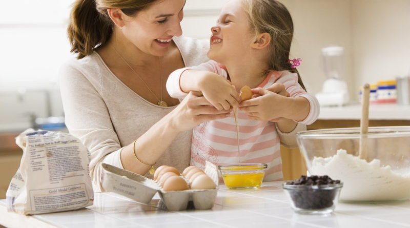 Caucasian mother and daughter baking together